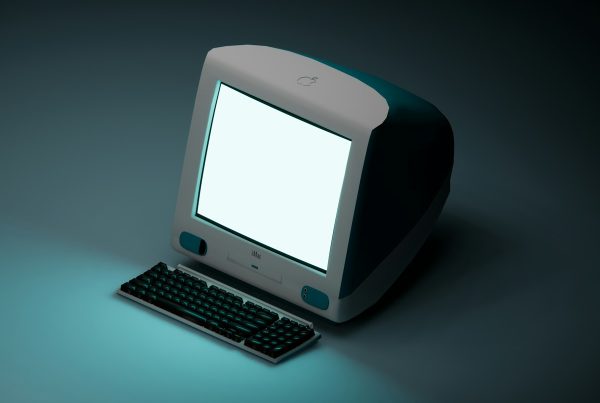 a computer with a white screen sitting on a table